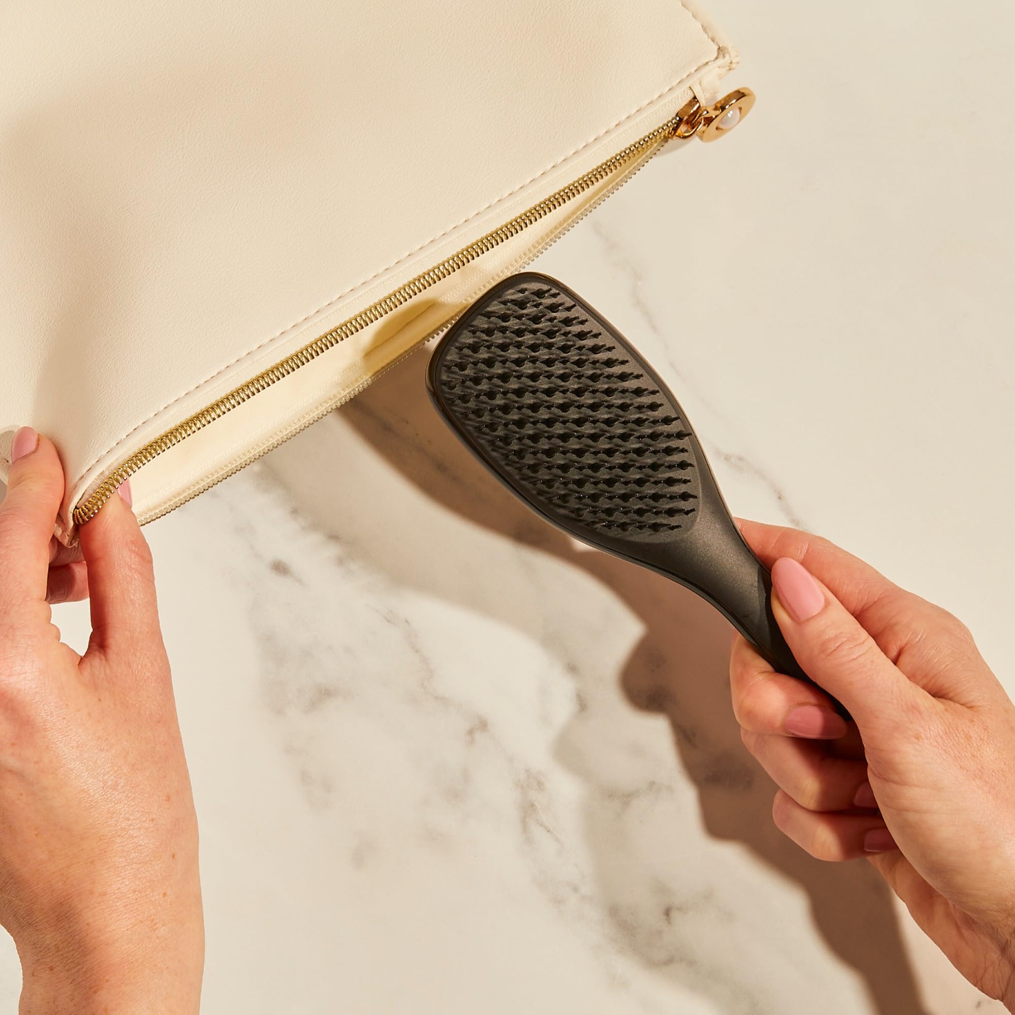 Tangle Teezer Ultimate Detangler soft teeth smoothing strands close-up.