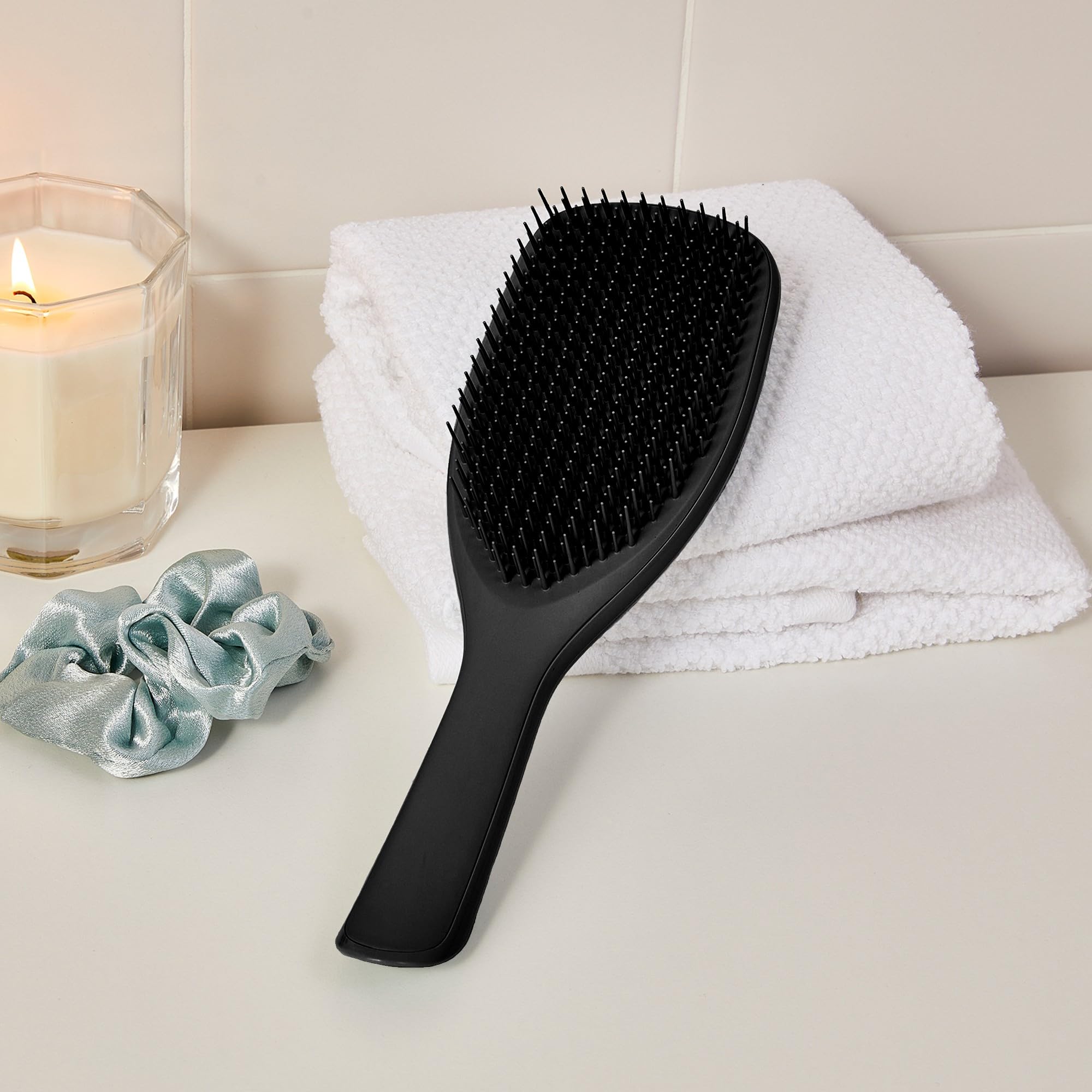Tangle Teezer shower-ready brush distributing conditioner evenly across hair.