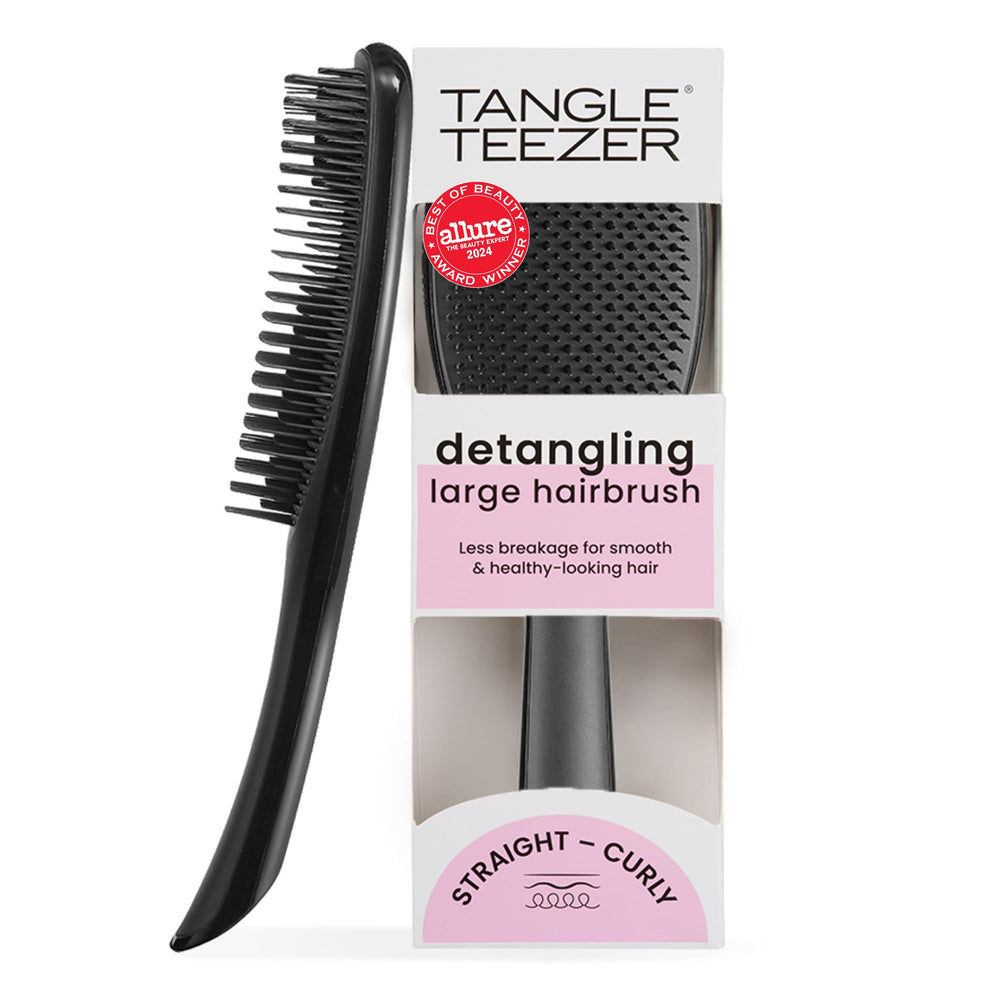Tangle Teezer Large Ultimate Detangler with wide paddle gliding through wet or dry hair for smoother results.