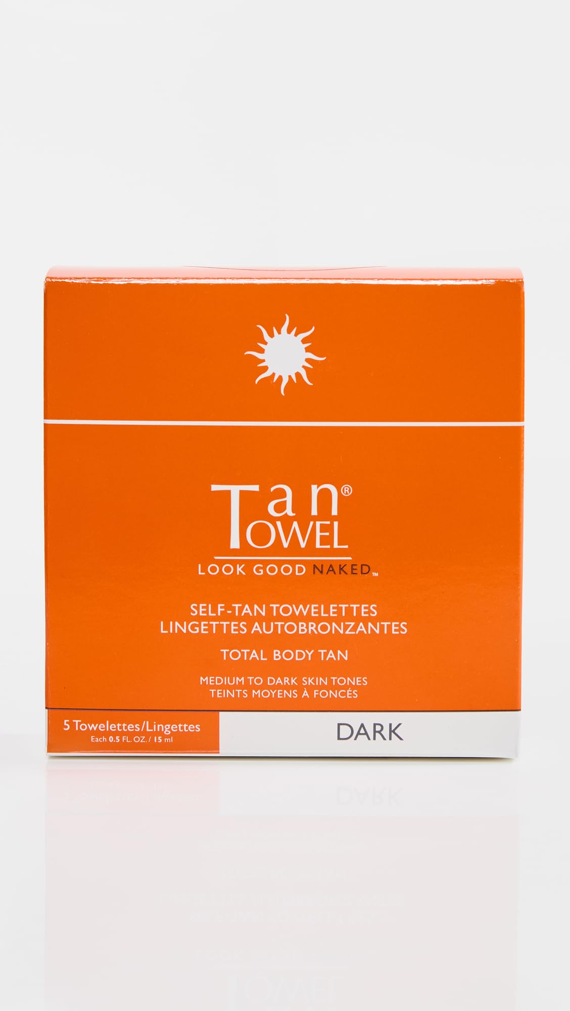 TanTowel Dark towelettes applying to skin for quick, mess-free self-tanning results.
