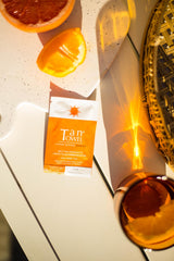 TanTowel half-body towelettes being unfolded for easy, streak-free application.