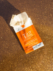 TanTowel towelettes applied on the arm for an even, natural glow.