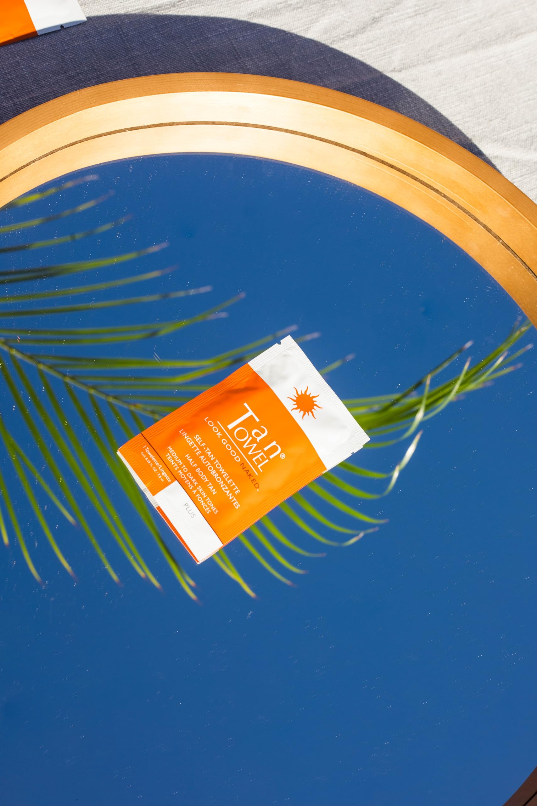 TanTowel half-body towelettes on skin delivering a natural sunless tan.