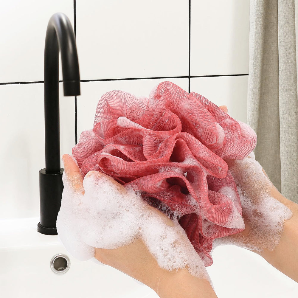 Esponja de baño Tbestmax azul con malla, ideal para generar espuma abundante.