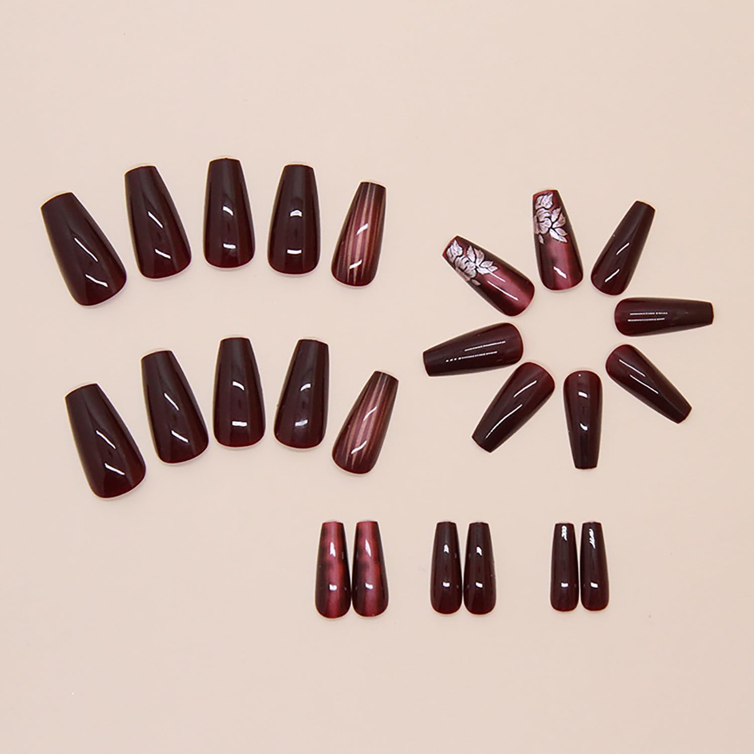 Uñas vino rojo con diseño floral y rayas para elegancia