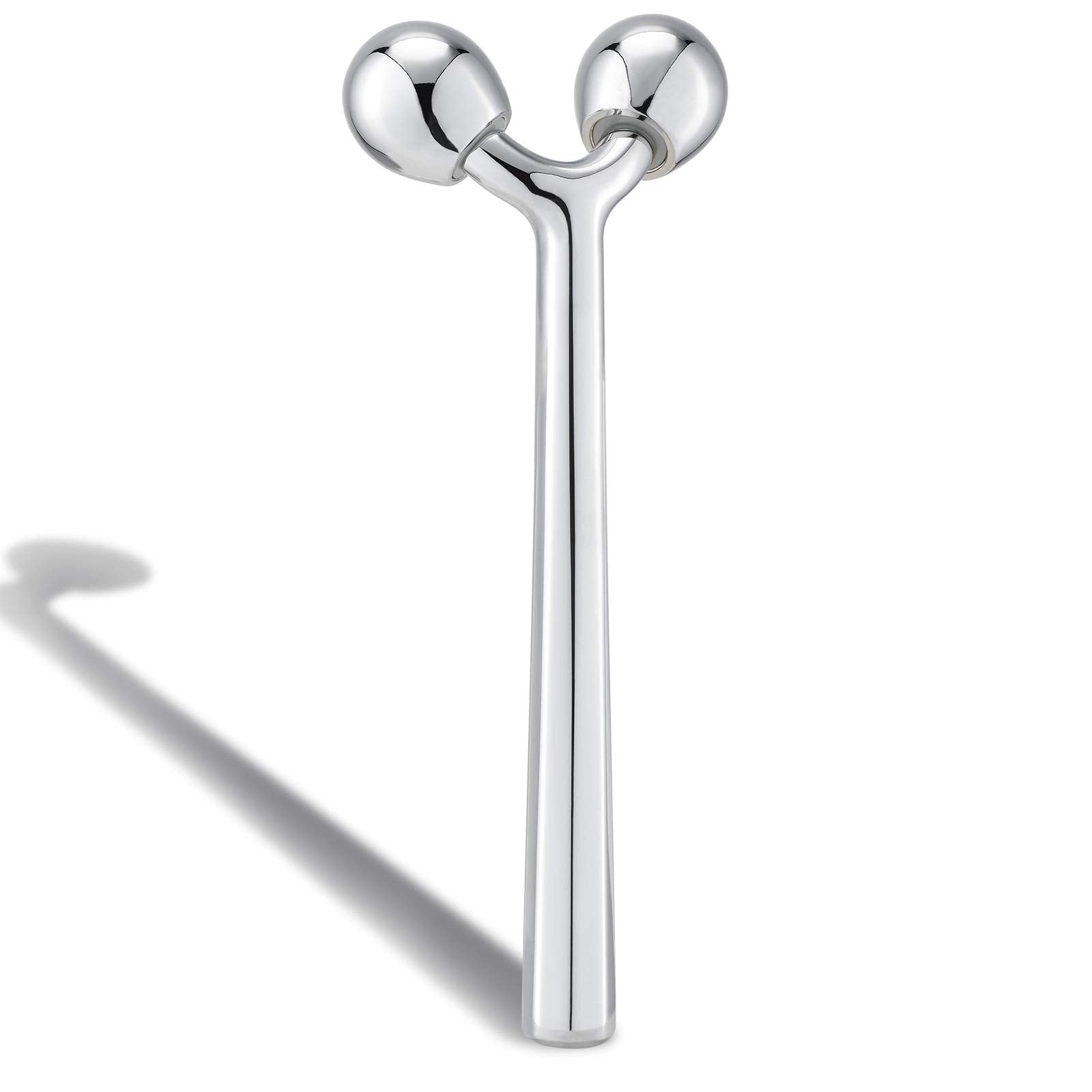 Tekson facial roller with 3D metal design delivering a smooth glide.