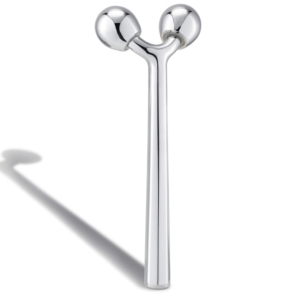 Tekson facial roller with 3D metal design delivering a smooth glide.