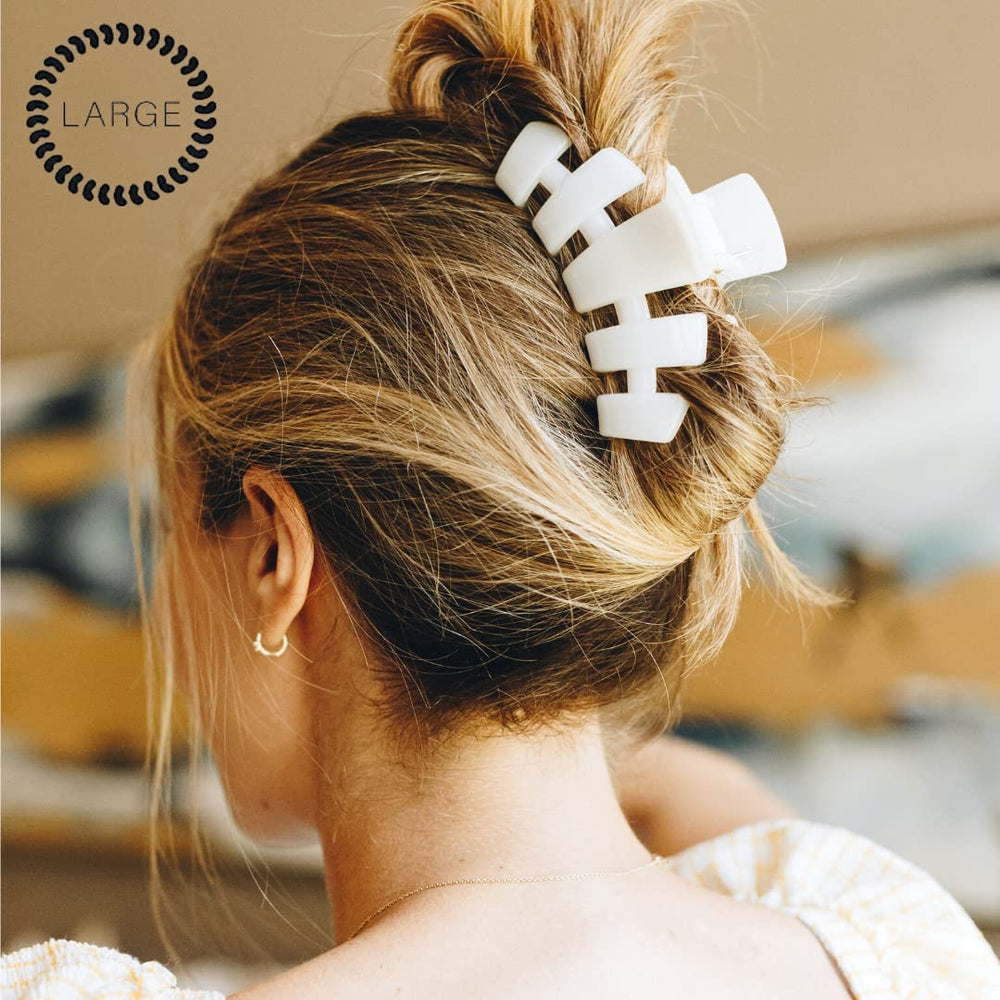 Teleties large hair clip on dense hair for secure hold.
