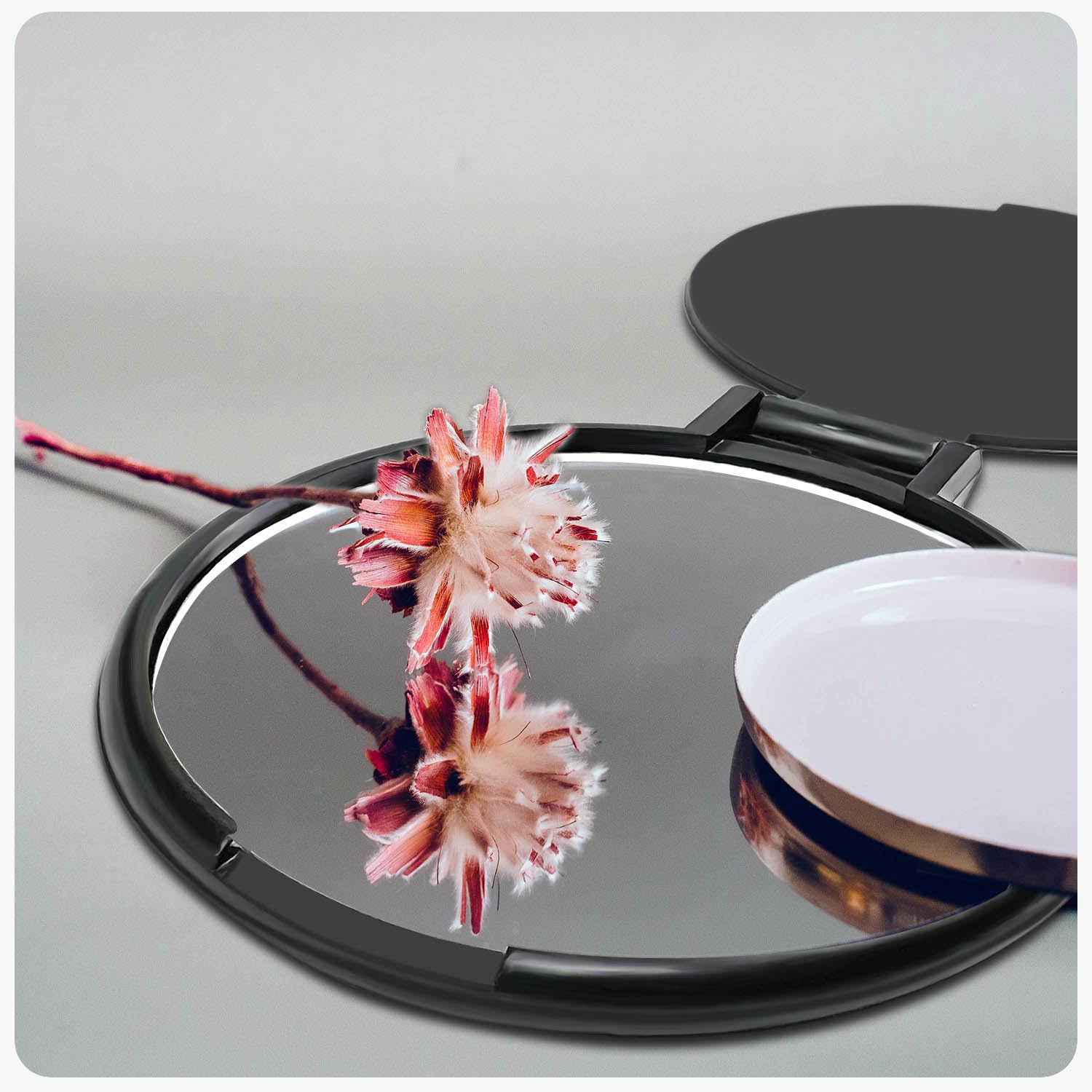 Tenalleys mini round folding mirror on table stand, perfect for hands-free makeup checks.