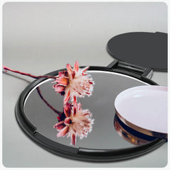 Tenalleys mini round folding mirror on table stand, perfect for hands-free makeup checks.