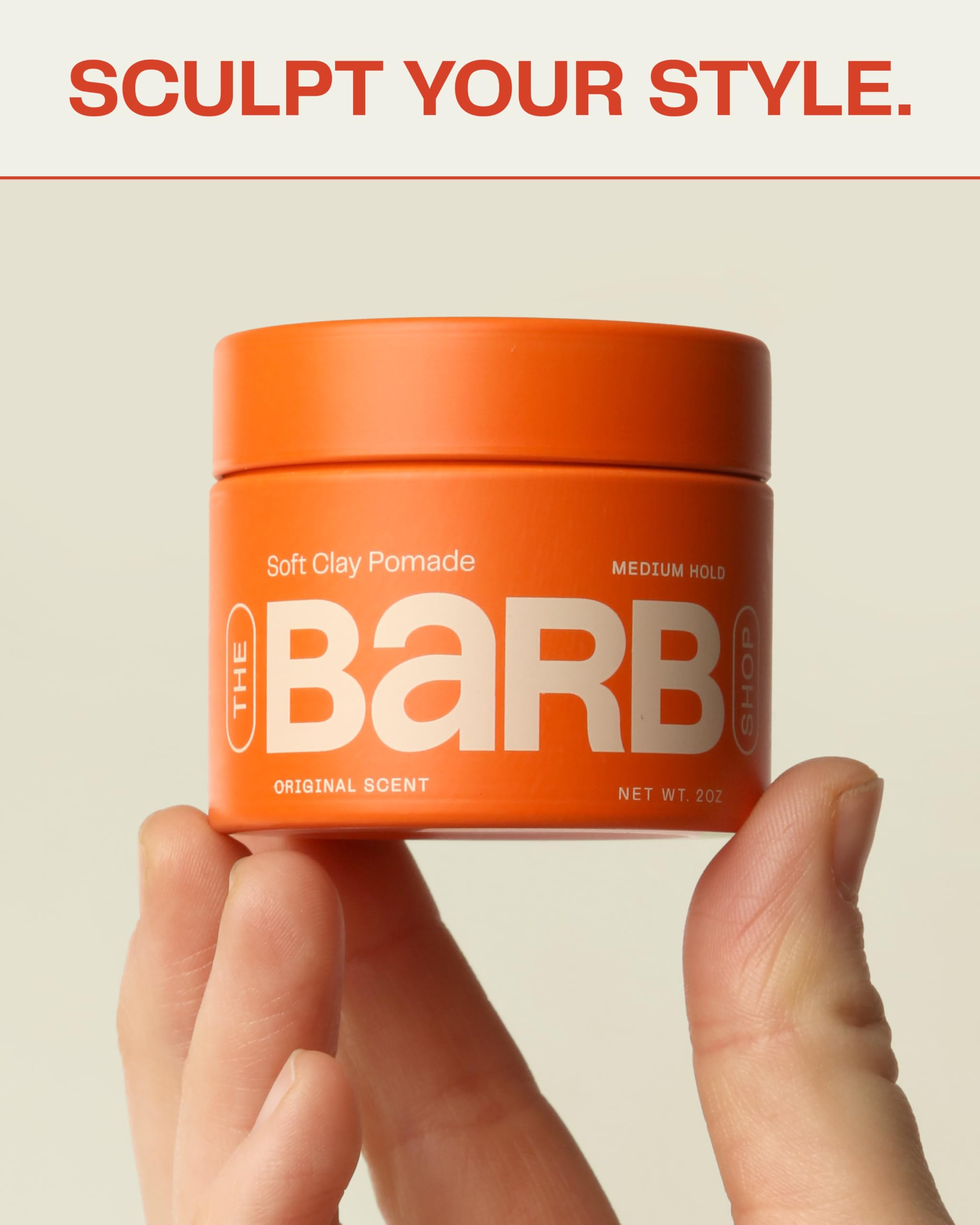The Barb Shop Barb Soft Clay Pomade hands applying for smooth spread.