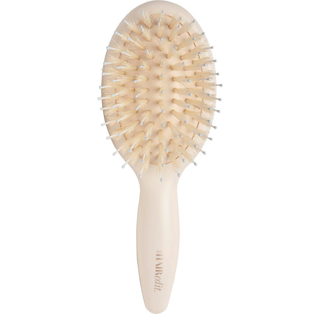 The Hair Edit mini brush close-up showing boar bristles for gentle detangling
