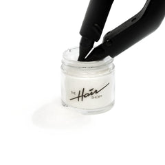 Close-up texture of The Hair Shop keratin glue powder ideal for bond reuse.