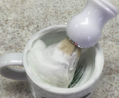 The Village Soapsmith Old Spice fragrance detail enhances the shaving ritual.