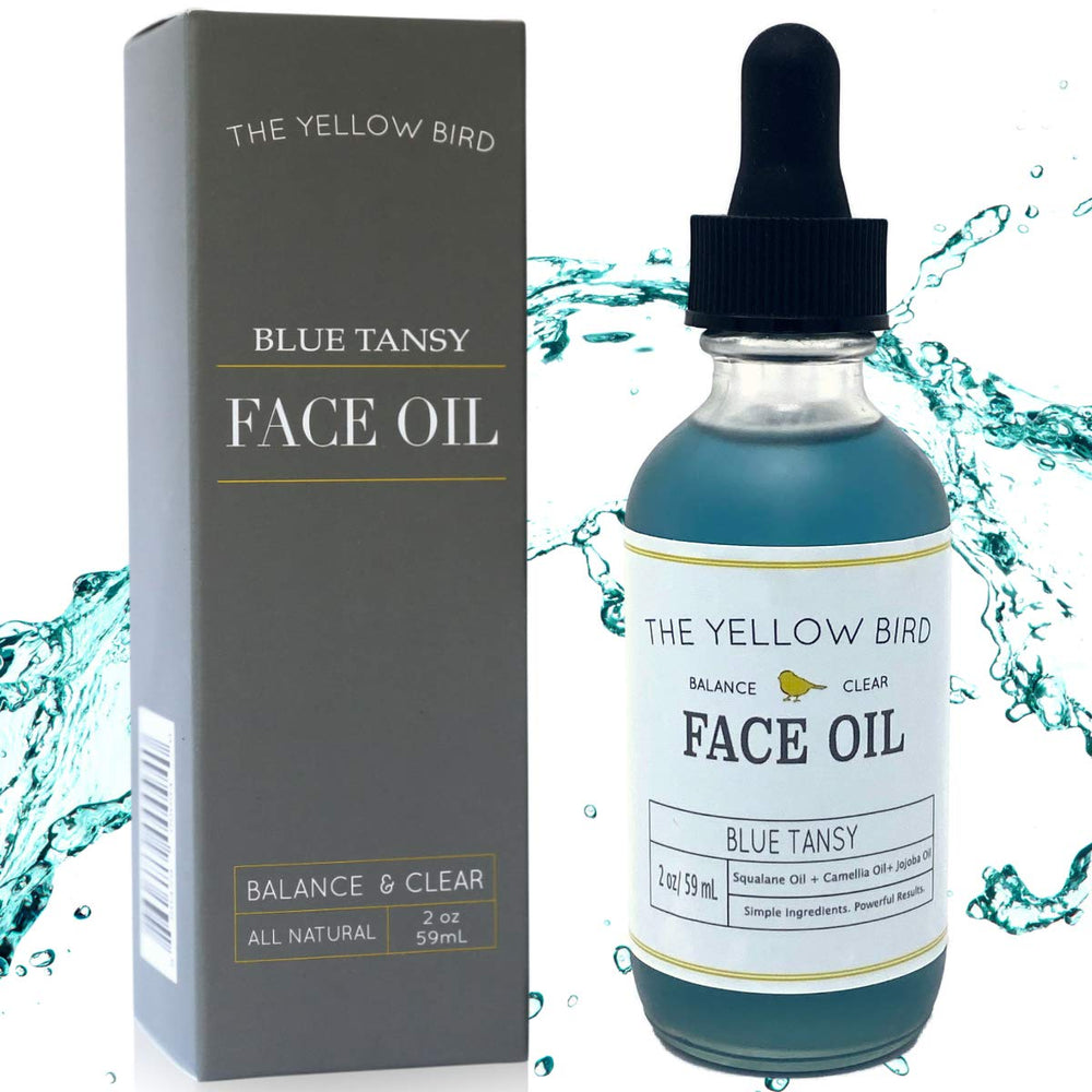 The Yellow Bird Balancing Blue Tansy face oil bottle close-up for radiant, balanced skin support.