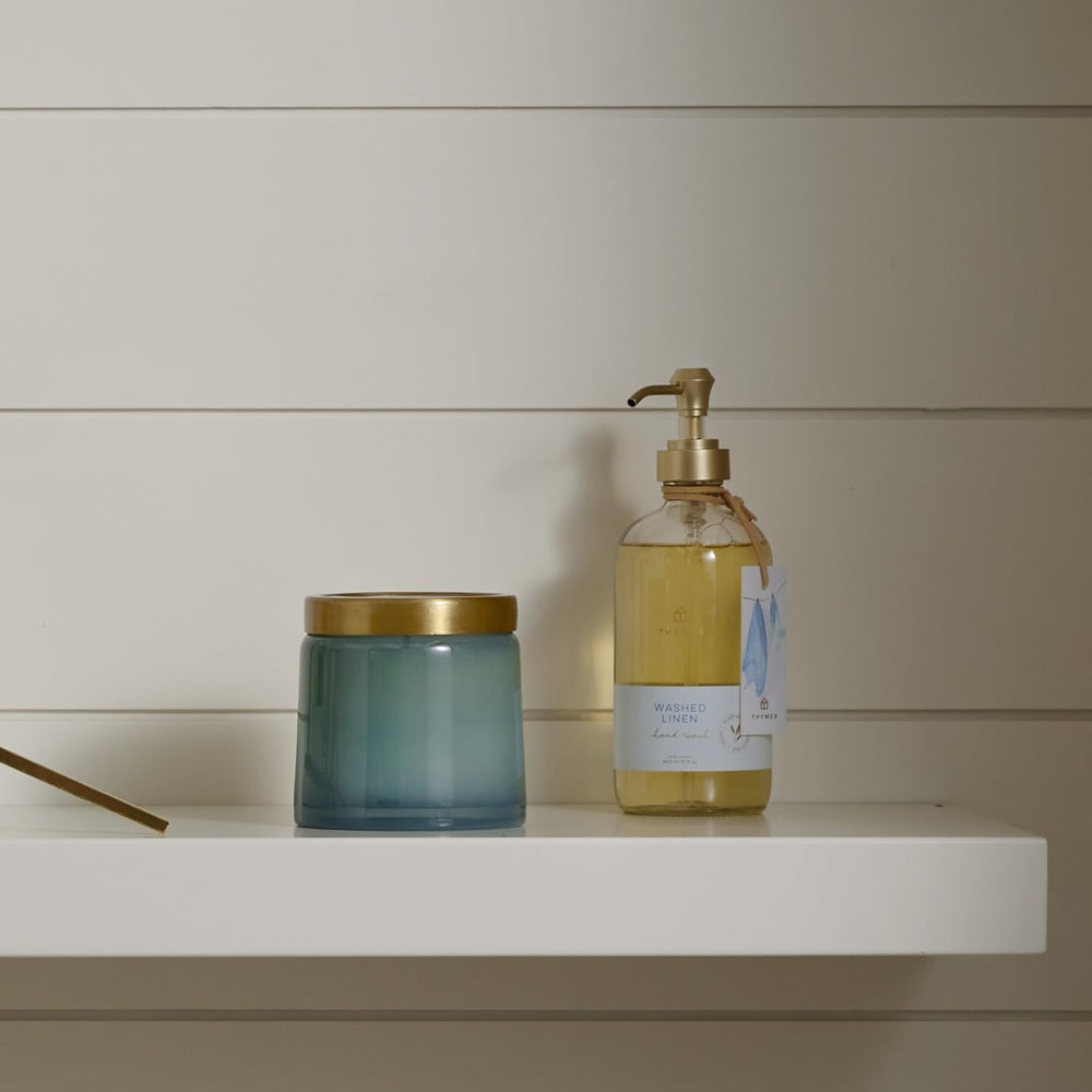 Thymes Hand Wash Washed Linen bottle on bathroom counter, inviting a calm routine.