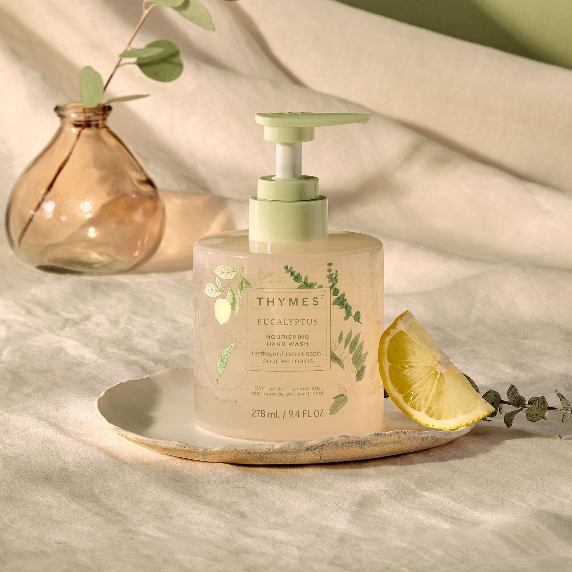 Close view of Thymes Nourishing Hand Wash bottle pour demonstrating dispensing