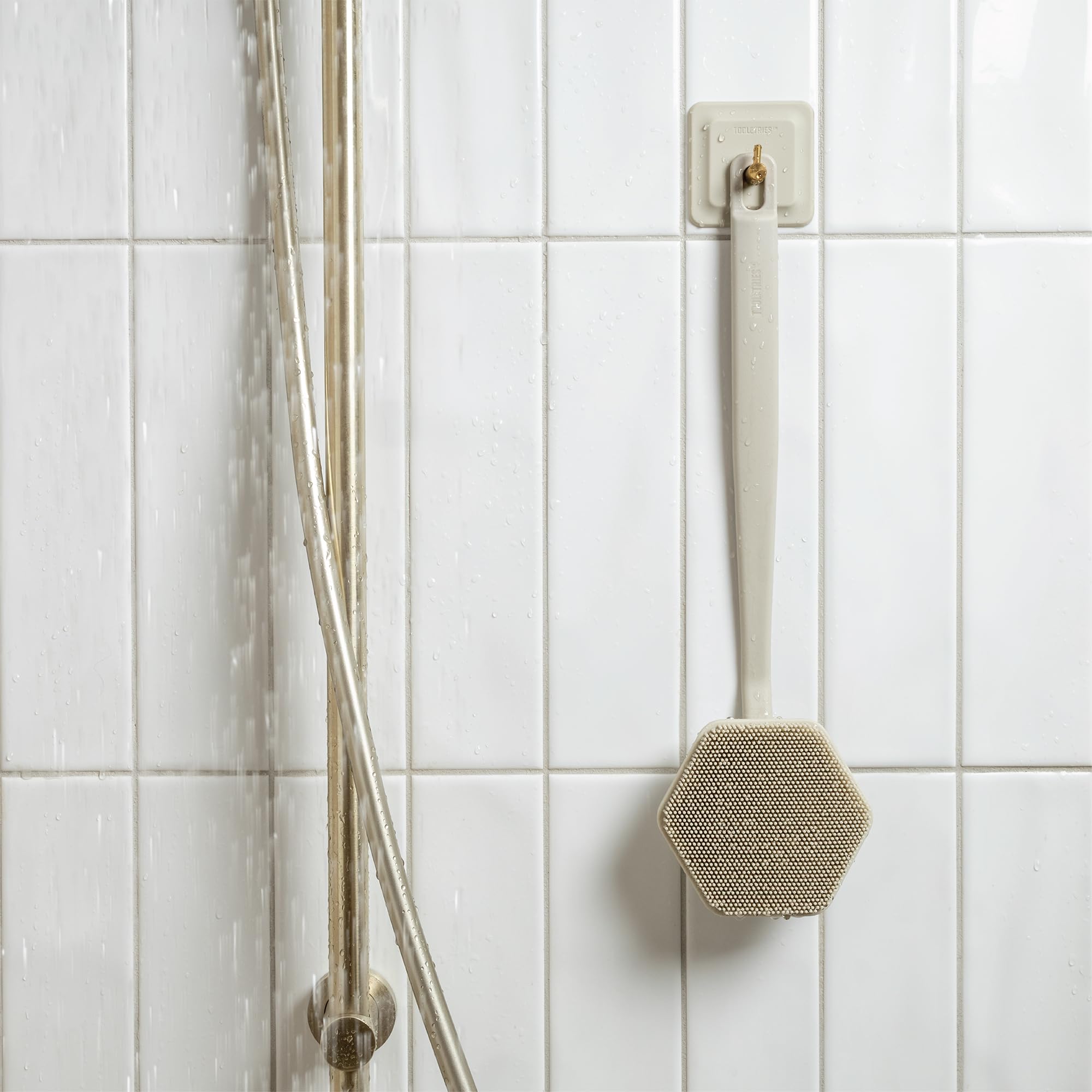 TOOLETRIES sand color back scrubber adds a stylish, durable shower accessory.