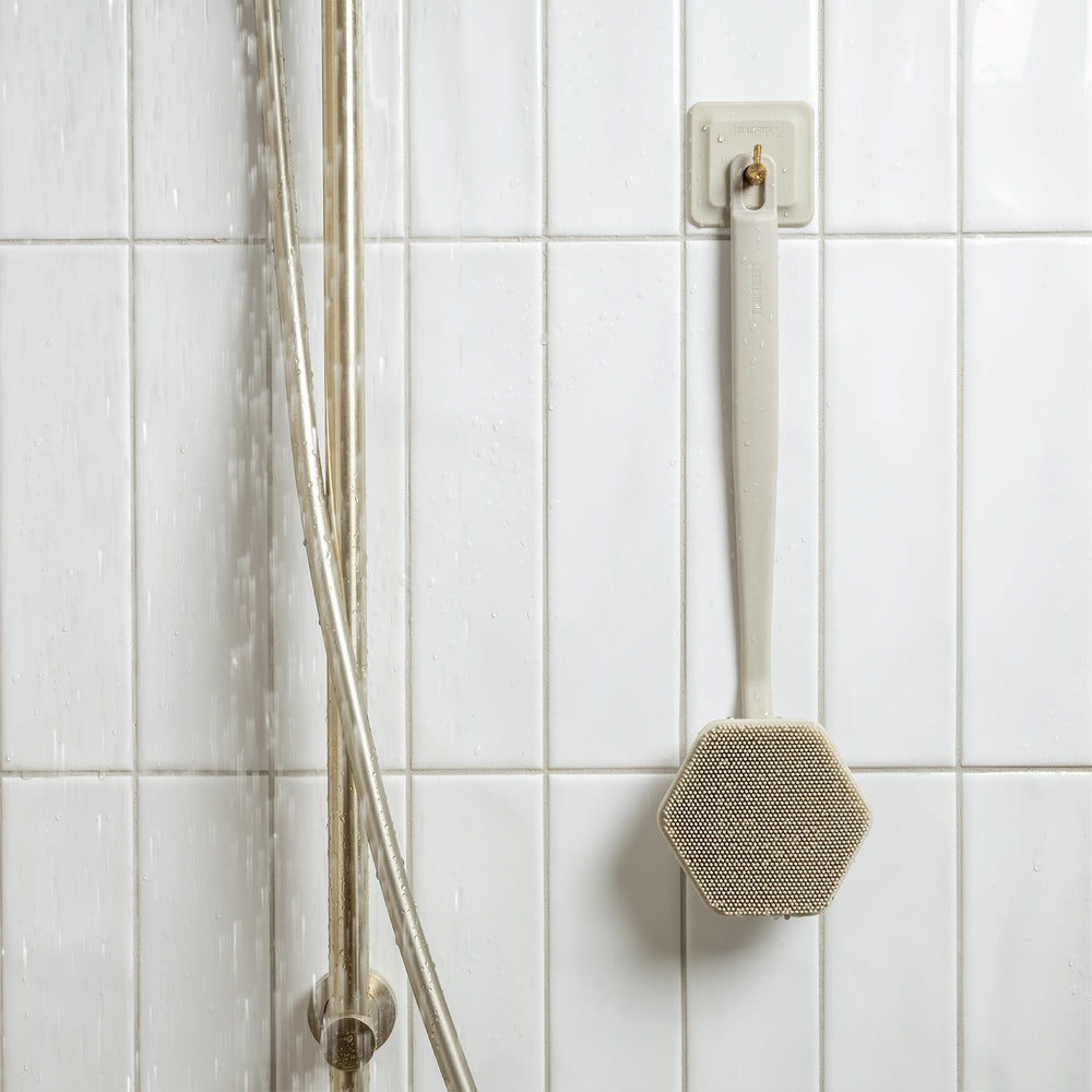 TOOLETRIES sand color back scrubber adds a stylish, durable shower accessory.
