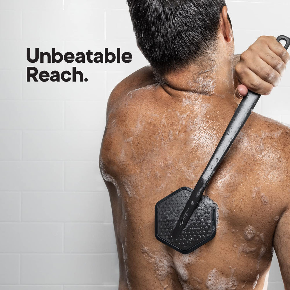 TOOLETRIES silicone back scrubber long handle in use on back.
