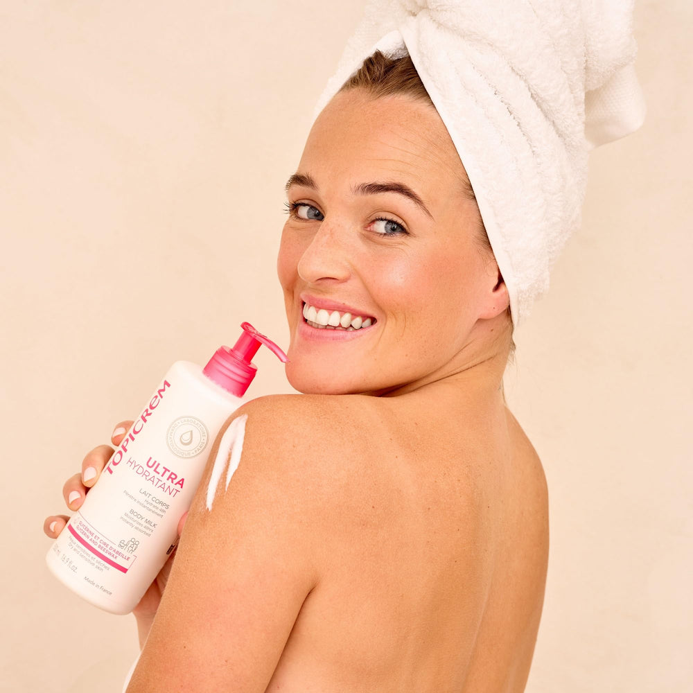 Topicrem body milk around elbows and knees, long-lasting hydration.