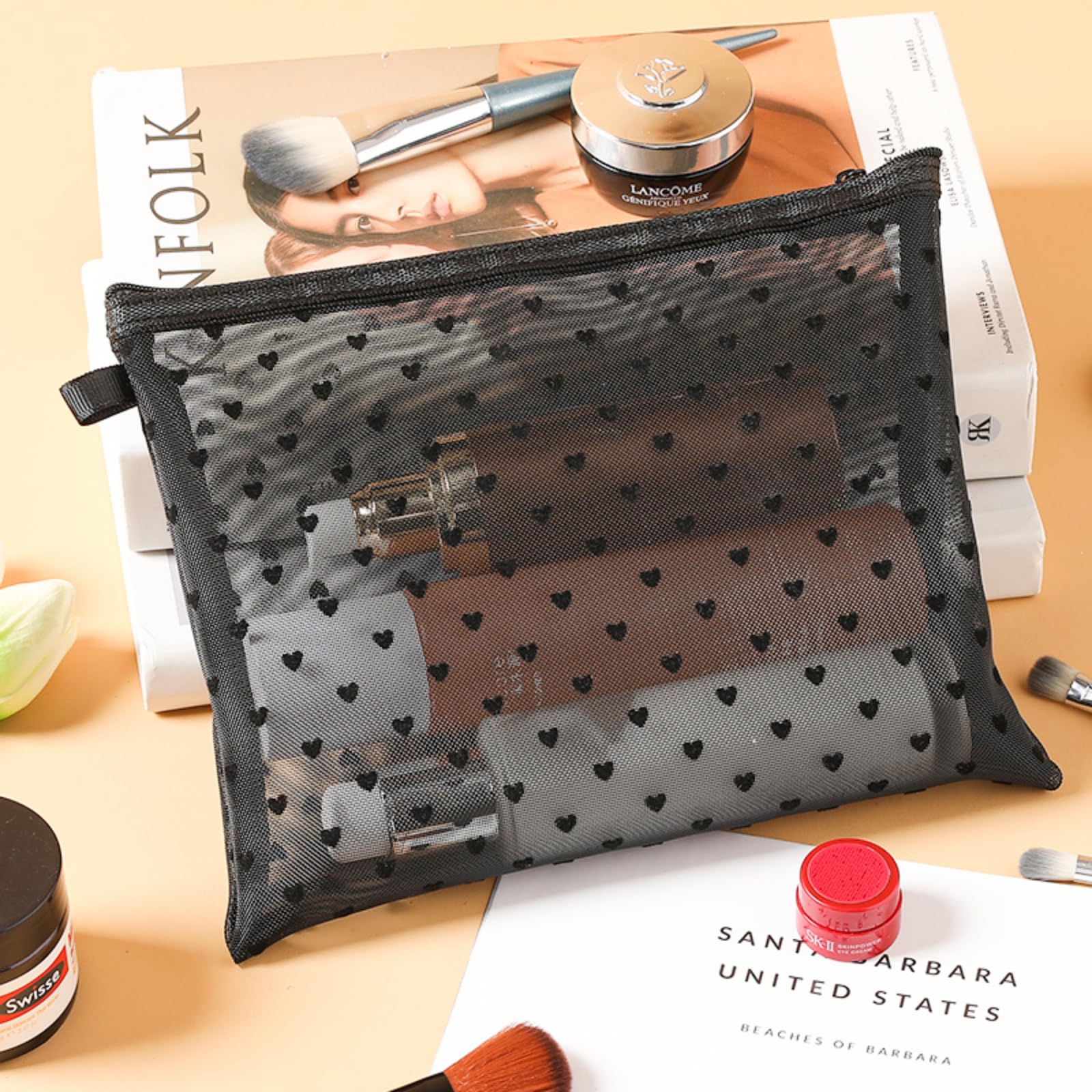 TRAKWAN mesh bag with zipper closure in black for secure access.