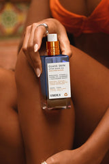 Close-up of Truly Glass Skin After Shave Oil bottle with luminous glow