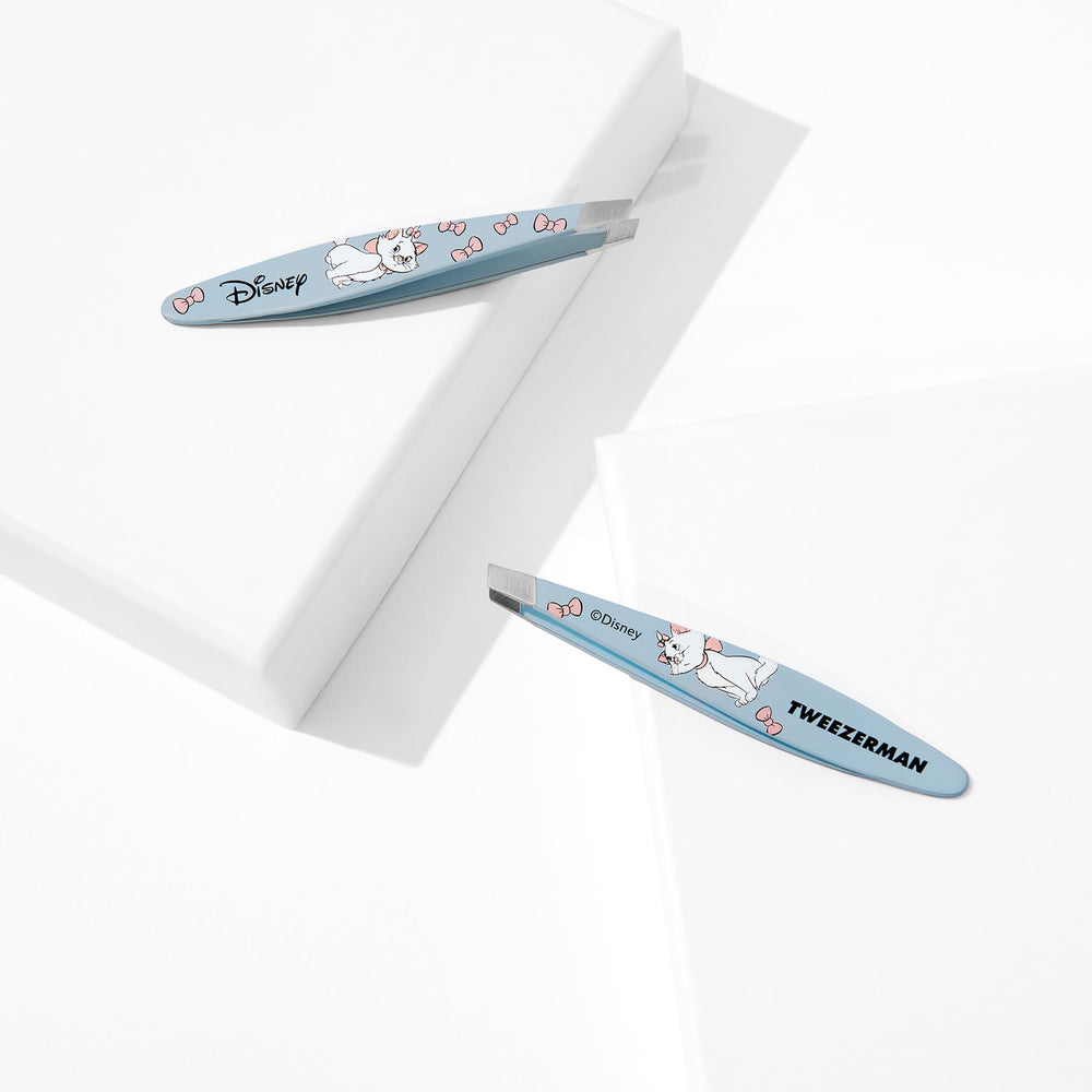 Tweezerman Aristocats mini slant tweezer packaging illustration shows compact travel-friendly tool.