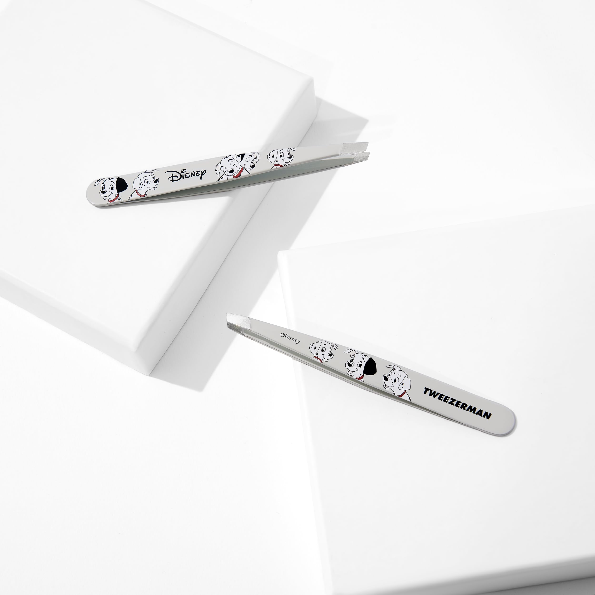 Tweezerman 101 Dalmatians tweezer in hand demonstrating precise control.