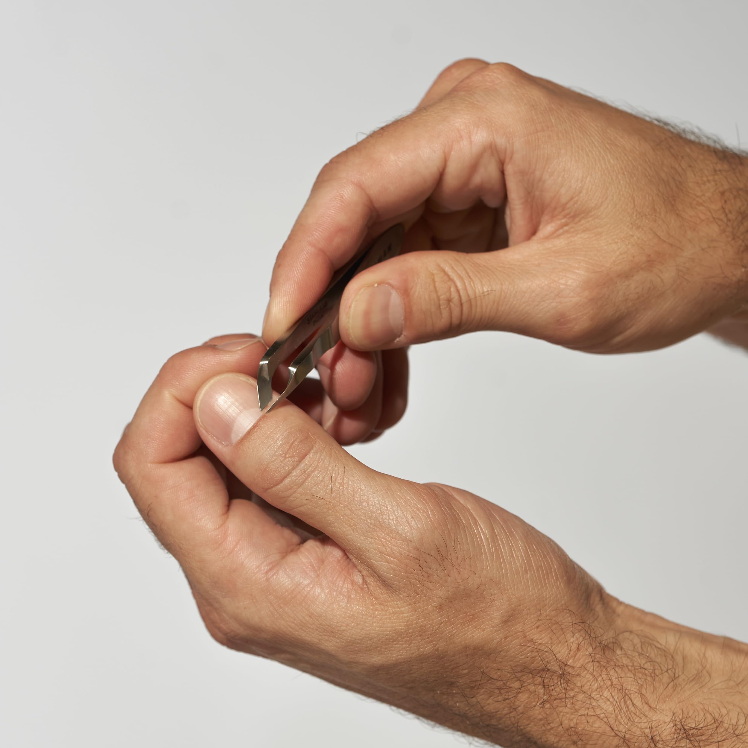 Tweezerman Mini Squeeze Cuticle Nipper handle with textured near-tip grip for control.