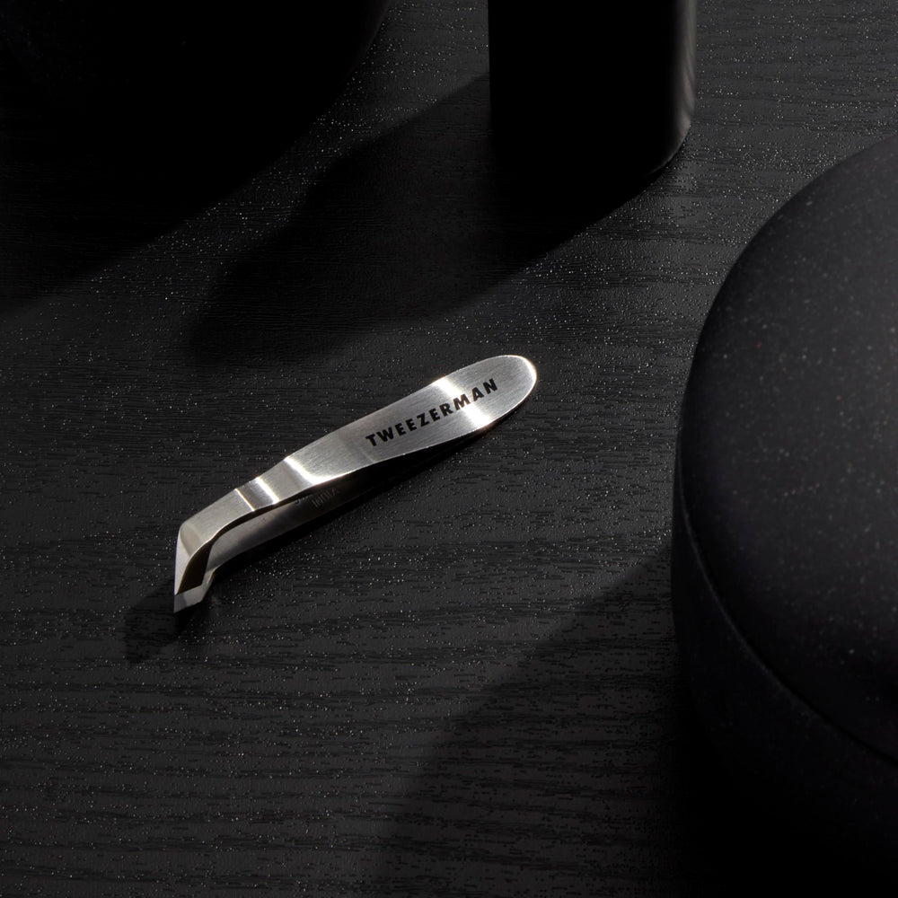 Tweezerman Mini Squeeze Cuticle Nipper in use for precise hangnail trimming.