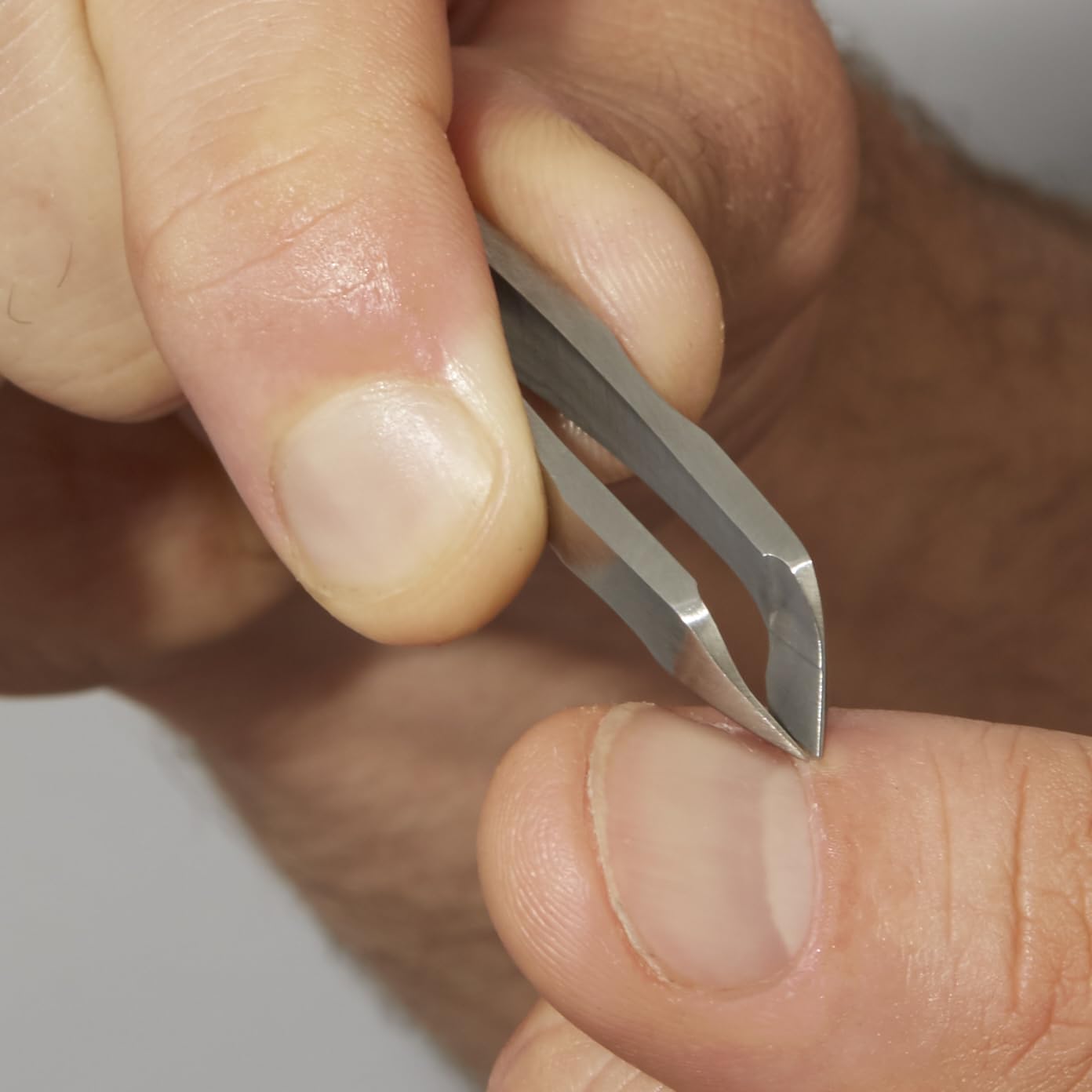 Tweezerman Mini Squeeze Cuticle Nipper close detail of textured near-tip control.