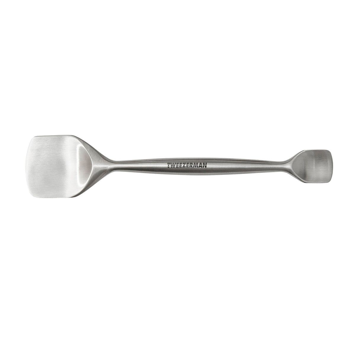Tweezerman Pore Prep Tool on the forehead with the large end for broad cleansing.