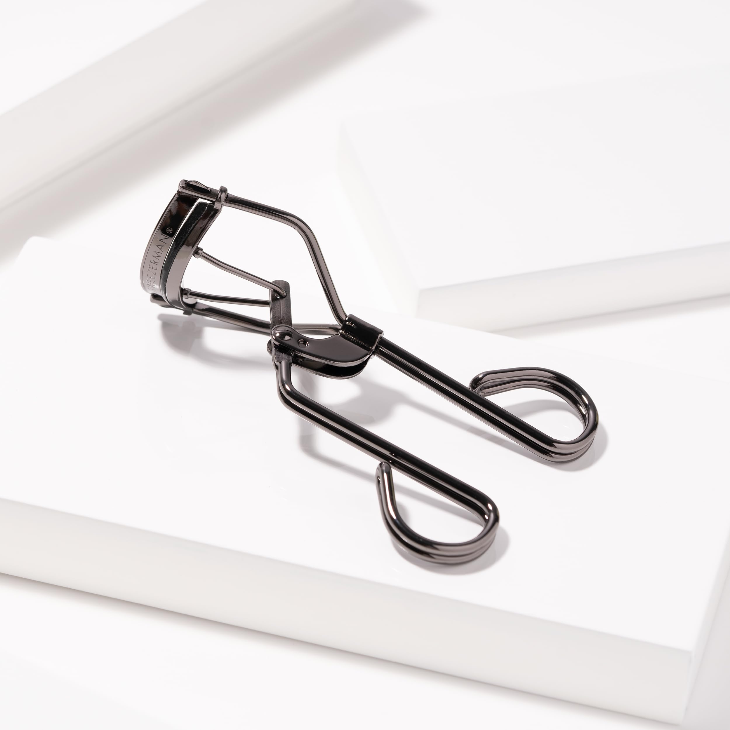 Tweezerman Pro Master Black Eyelash Curler close-up showing curling action on lashes