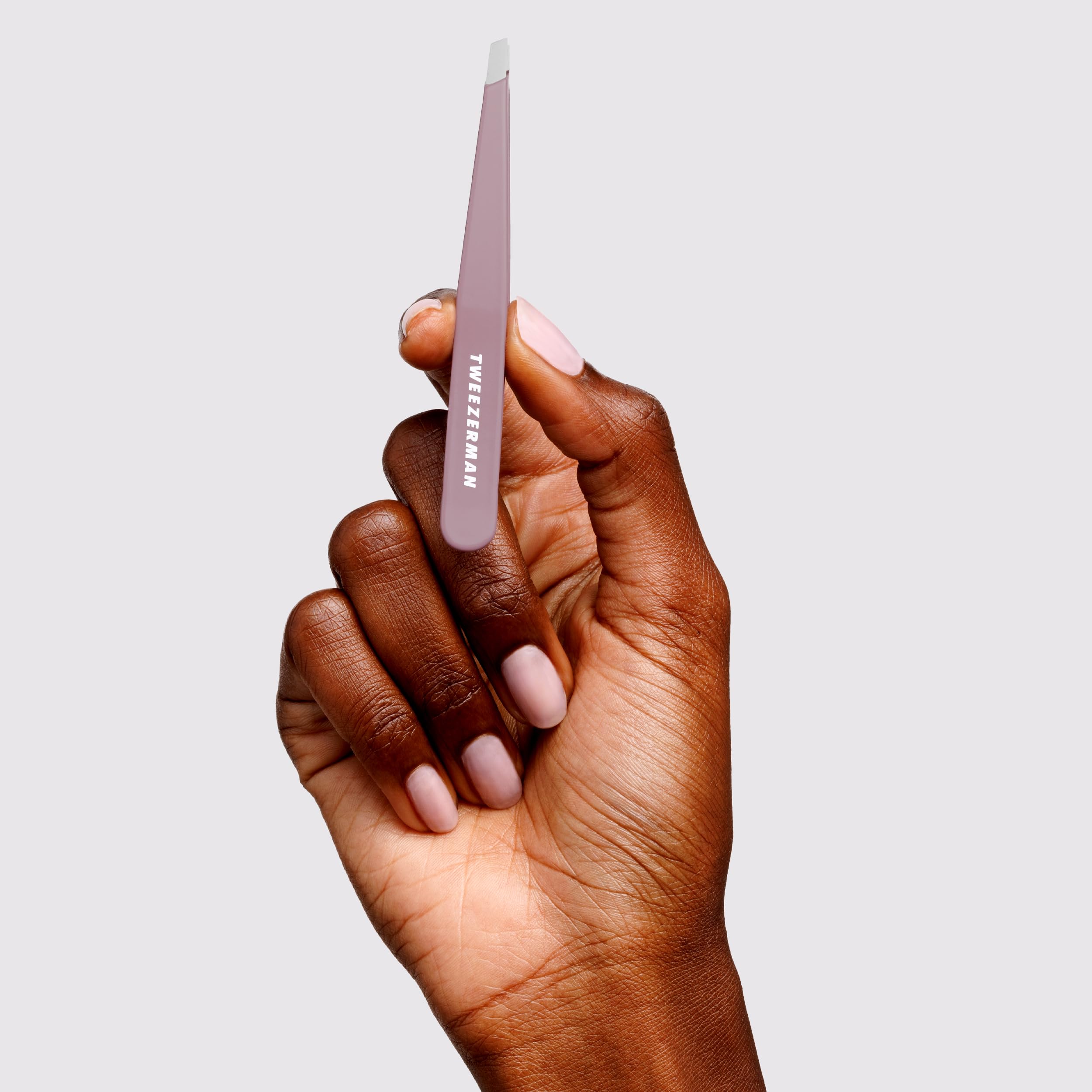Tweezerman Purple Wisteria Slant Tweezer calibrated tension enhances control.