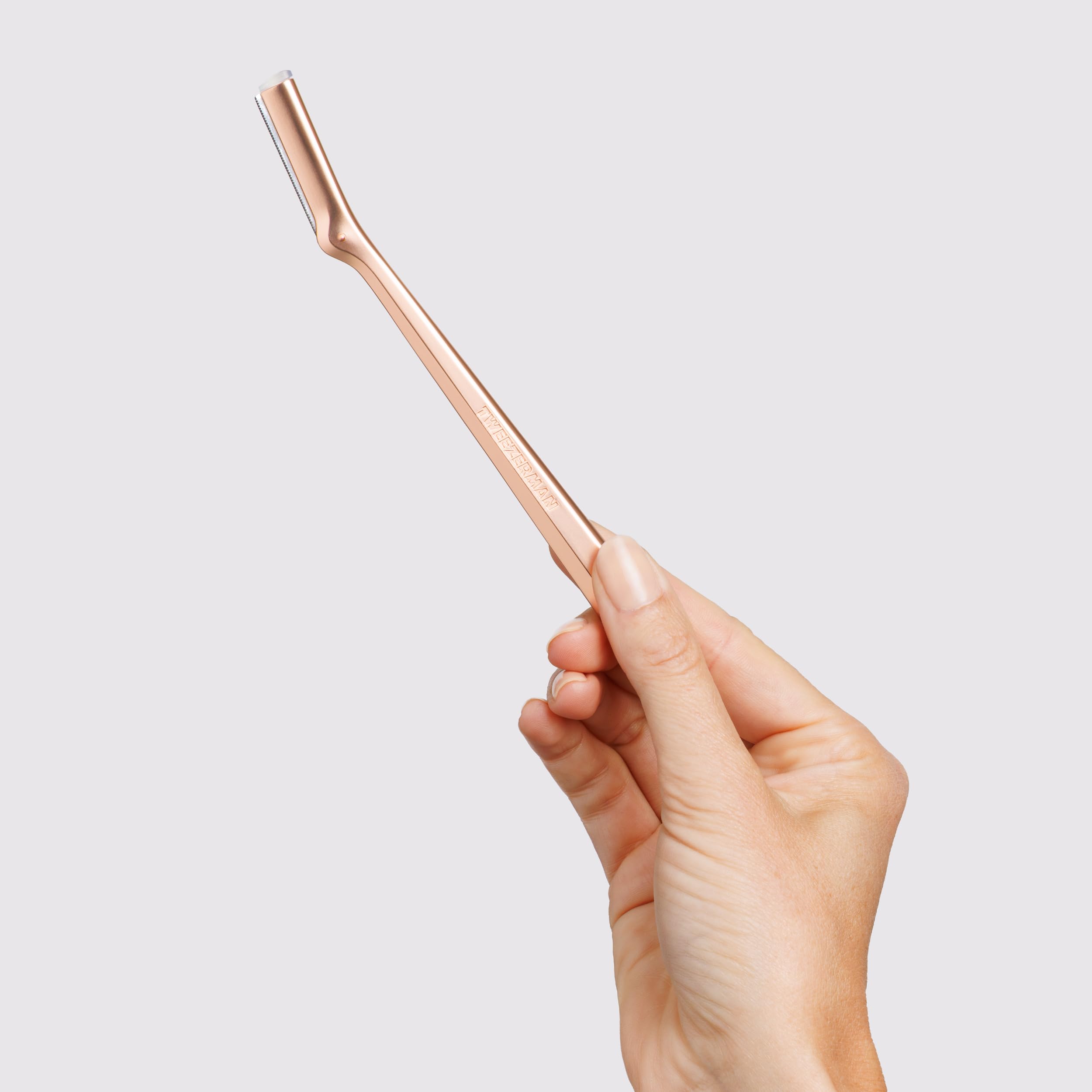 Tweezerman Rose Gold Facial Razor replacement blade being installed