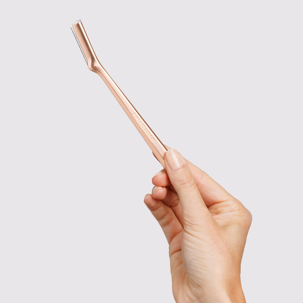 Tweezerman Rose Gold Facial Razor replacement blade being installed