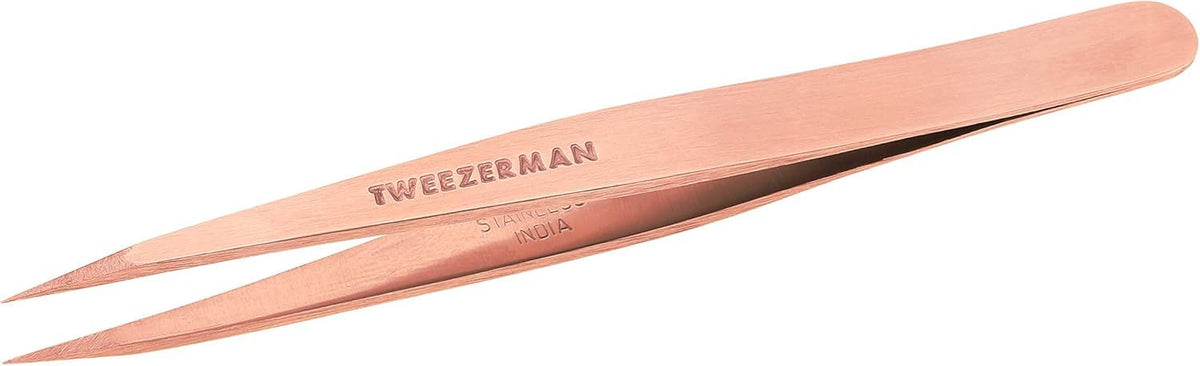 Tweezerman stainless steel point tweezer rose gold tip close-up for precision hair removal