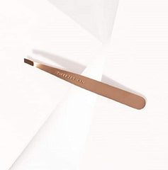 Tweezerman rose gold slant tweezer shown with makeup bag for travel grooming