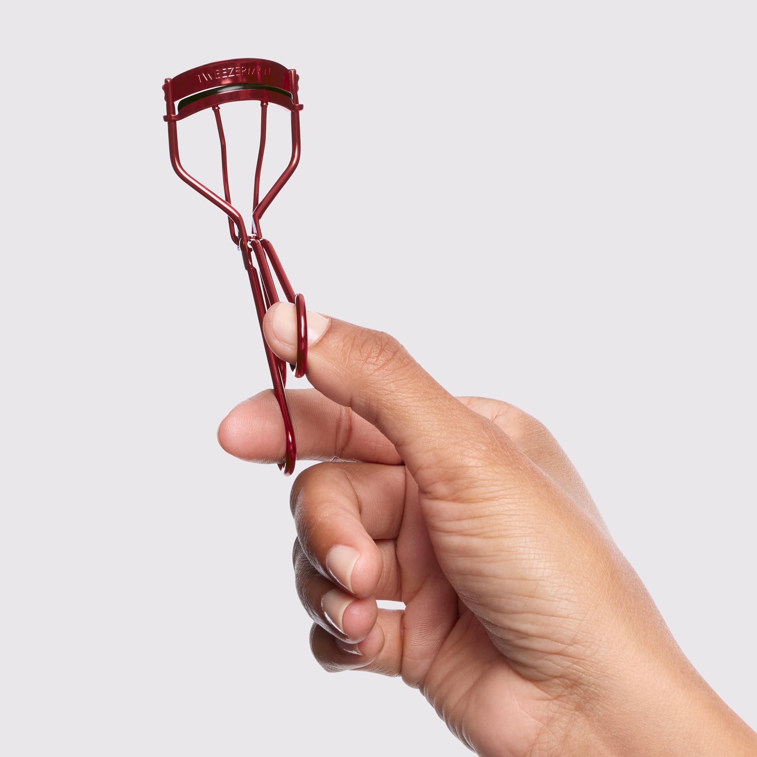 Tweezerman Classic Lash Curler in hand delivering a wide-awake look