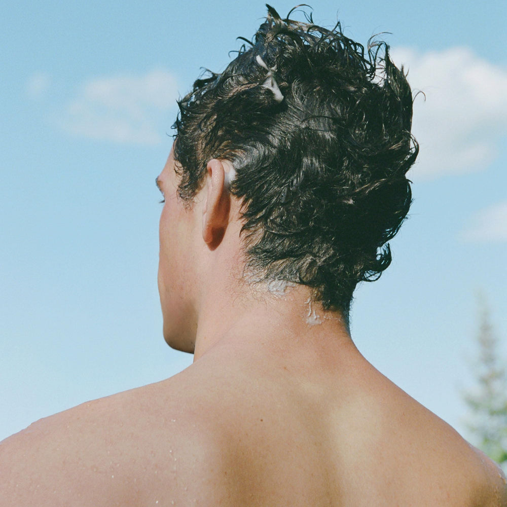 Ursa Major Go Easy Daily Shampoo fragrance close-up highlights warm woodsy scent with ginger and fir.
