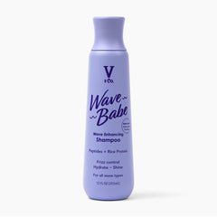 V&Co Wave Babe shampoo bottle on shelf showing frizz-control promise