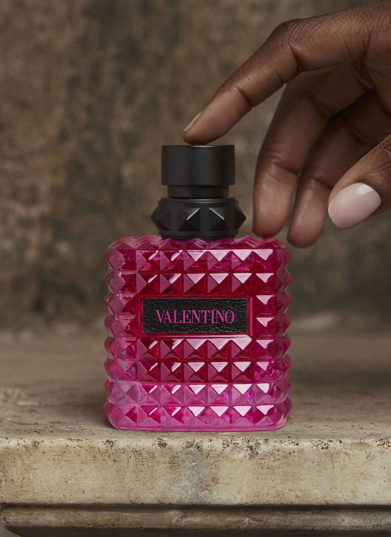 Valentino Born in Roma Extradose glass bottle with vanilla warmth note on display.