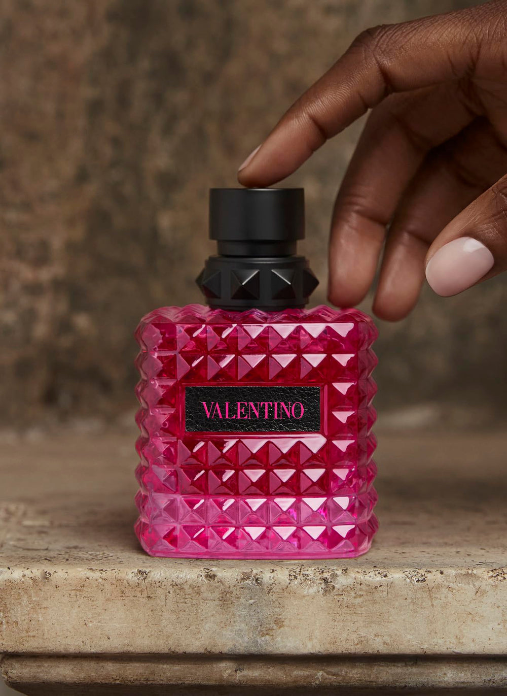 Valentino Born in Roma Extradose glass bottle with vanilla warmth note on display.