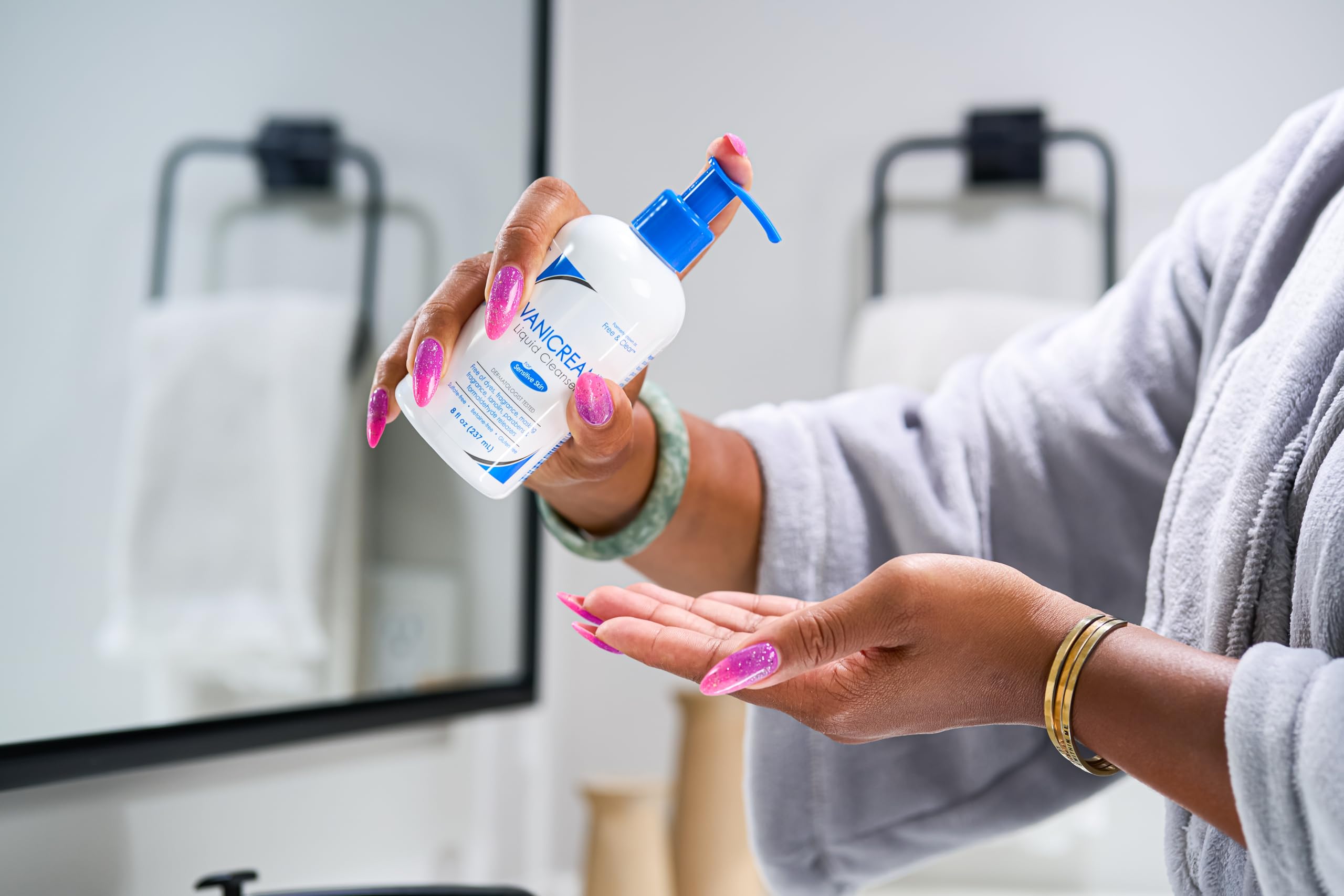 Vanicream Liquid Cleanser hands applying to face for gentle cleansing.