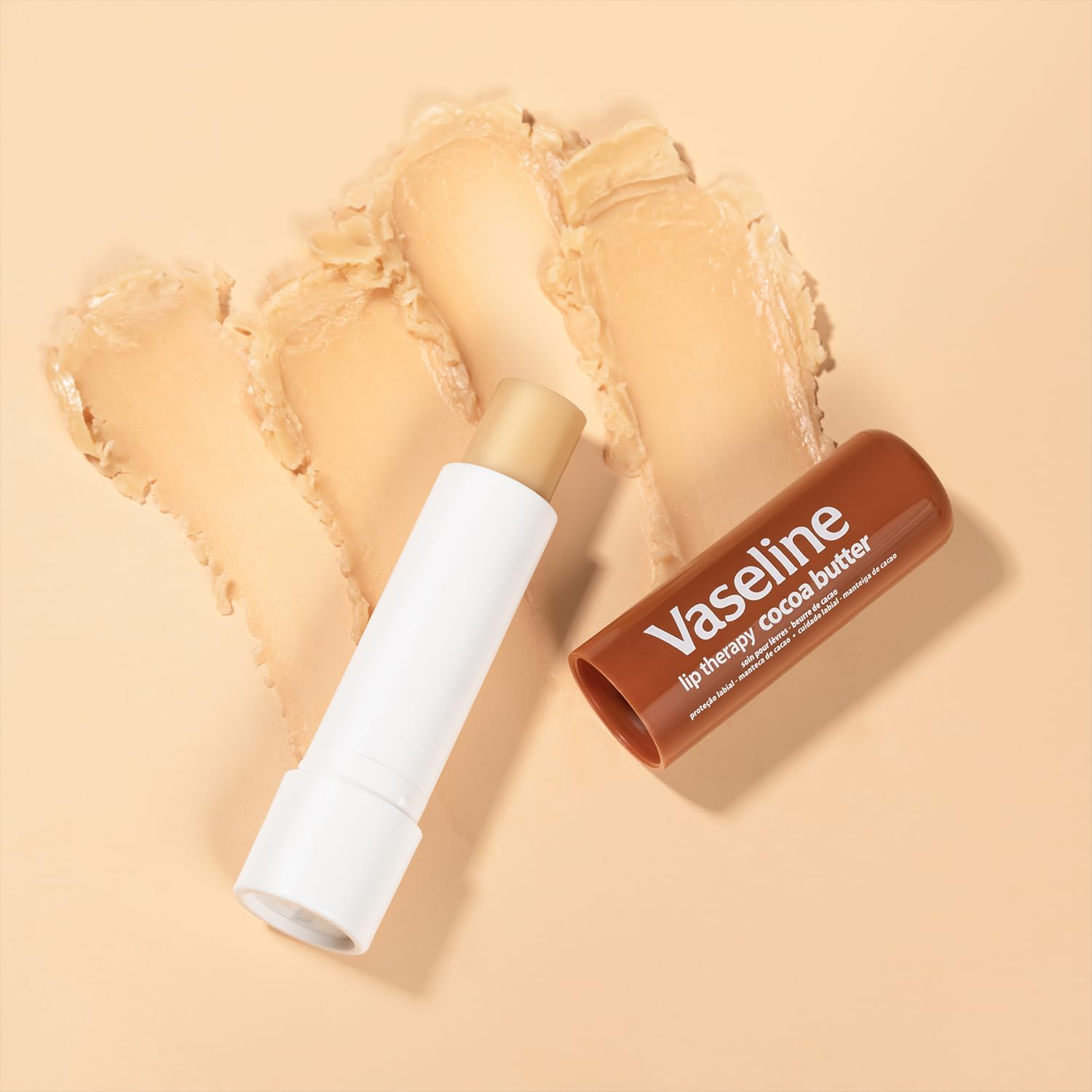 Vaseline Cocoa Radiant Lip Therapy being applied to lips for smoothness.