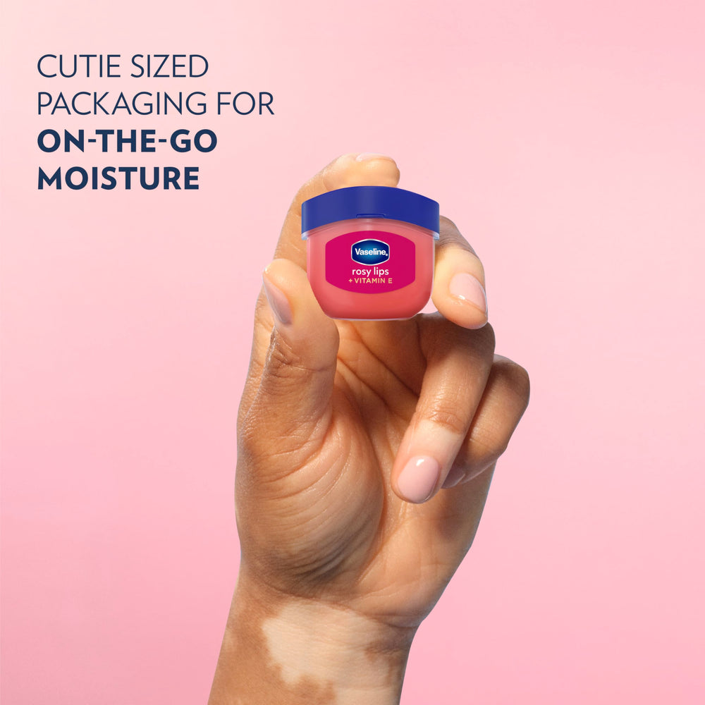 Applying Vaseline Lip Therapy Rosy Lips Mini to hydrate lips.