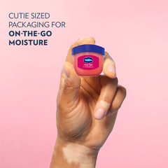 Applying Vaseline Lip Therapy Rosy Lips Mini to hydrate lips.