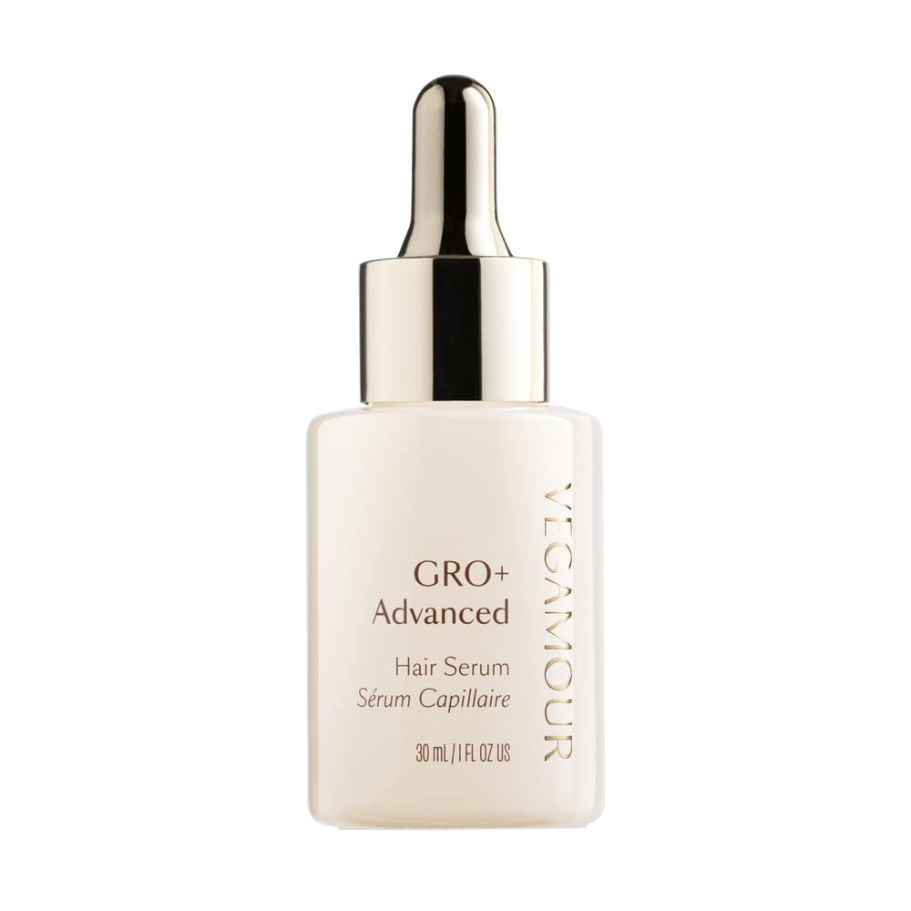 VEGAMOUR GRO+ serum bottle on a bathroom counter for daily scalp nourishment.