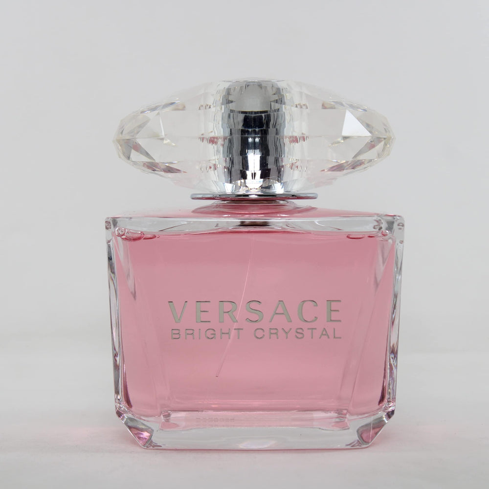 Versace Bright Crystal bottle on a warm vanilla surface